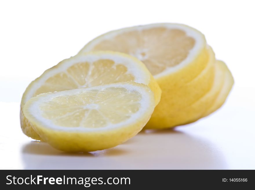 Sliced lemon fruit isolated on white. Copy space. Sliced lemon fruit isolated on white. Copy space.
