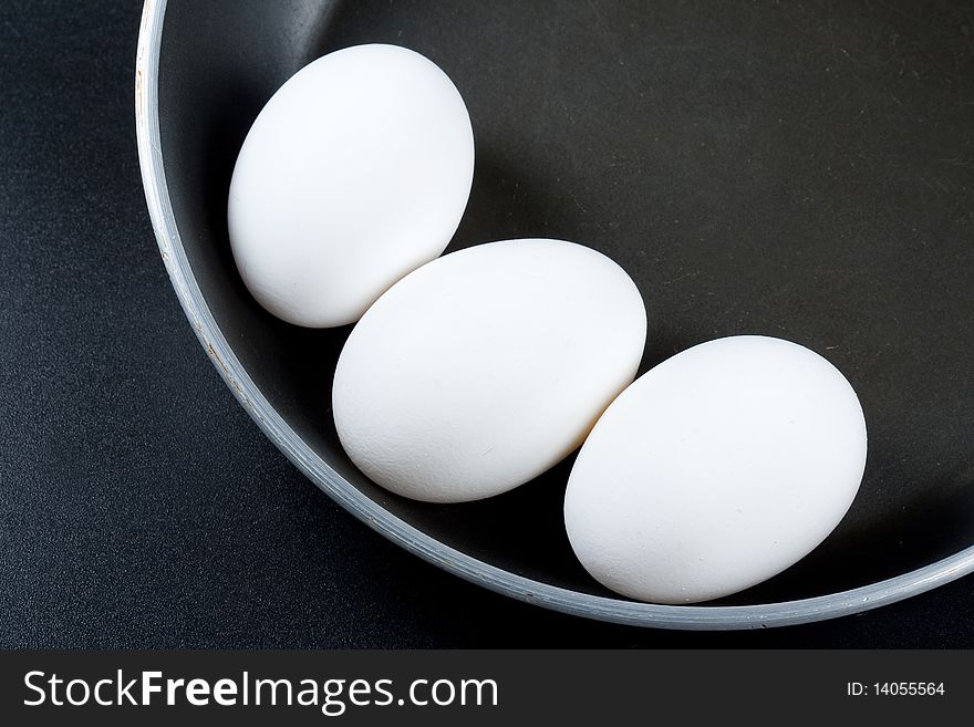 Three eggs of a hen on a frying pan