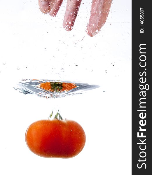 Tomato drops into the water