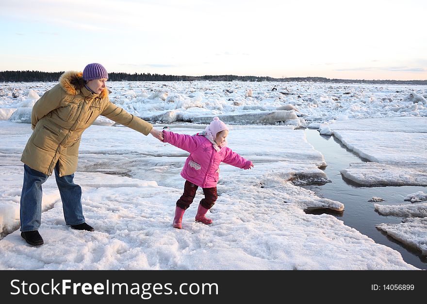 The mother stopped playing the child on the dangerous ice. The mother stopped playing the child on the dangerous ice.
