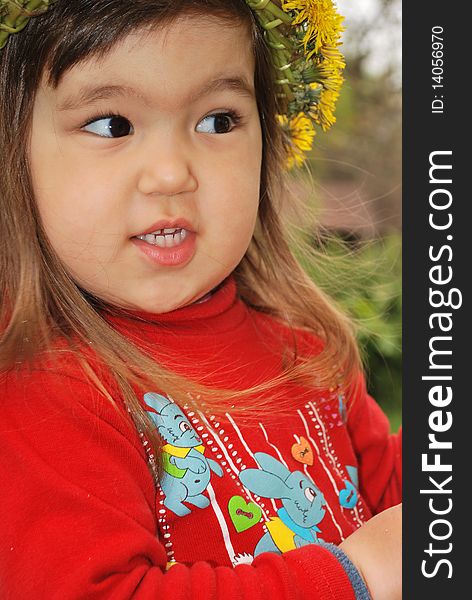 Closeup of a little girl wearing a dandelion diadem. Closeup of a little girl wearing a dandelion diadem