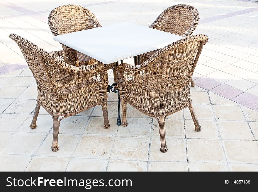 Brown wooden chairs an tables on patio