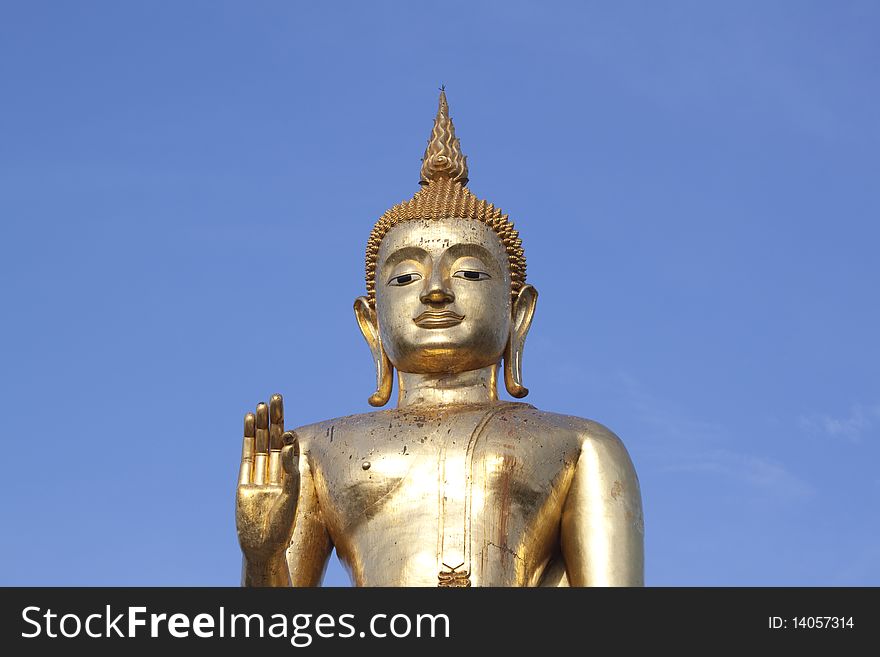 Buddha in Thailand with blue sky