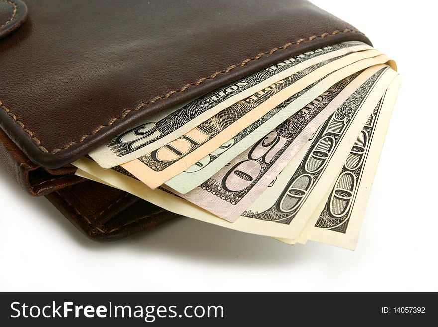 Dollars banknotes in leather brown purse on white background. Dollars banknotes in leather brown purse on white background