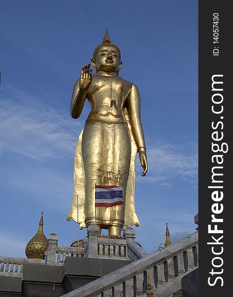 Buddha in Thailand with blue sky