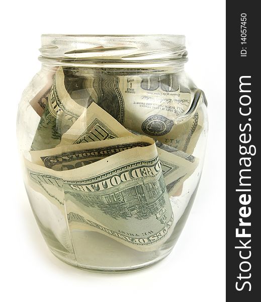 Dollar bills in glass jar on white background. Dollar bills in glass jar on white background