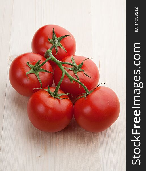 Red beauty tomatoes on wood