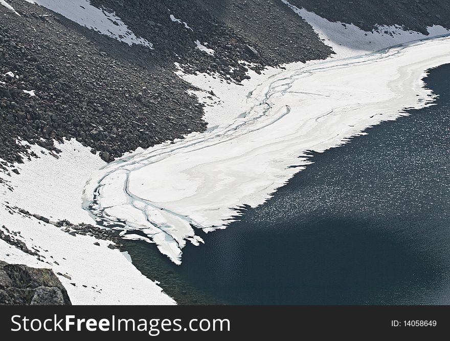 Slope of a mountain covered with melting ice. Slope of a mountain covered with melting ice