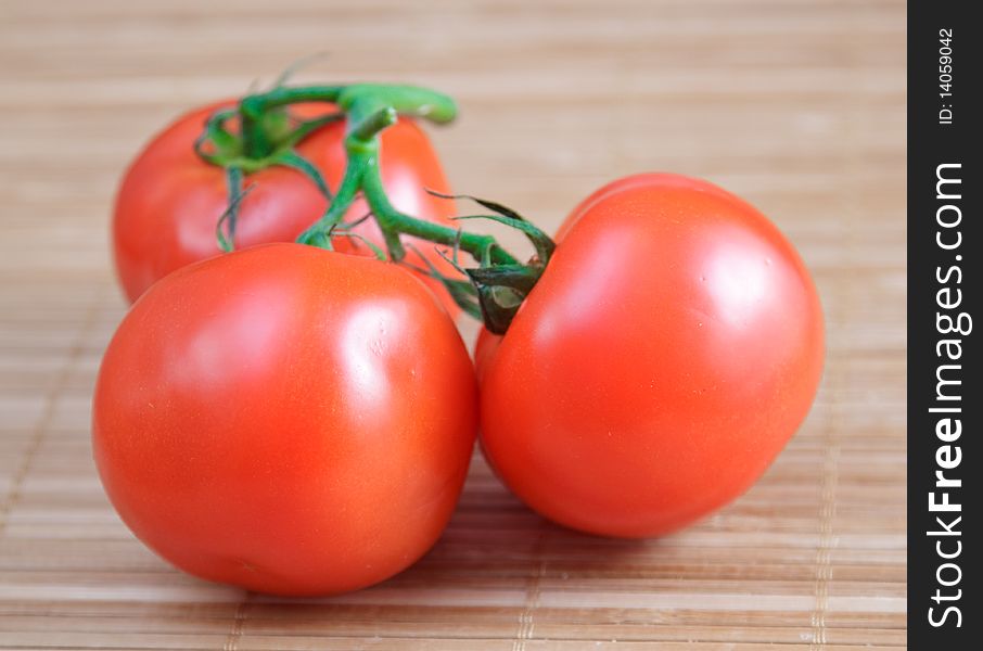 Red salad and tomato on brown bamboo napkin. Red salad and tomato on brown bamboo napkin