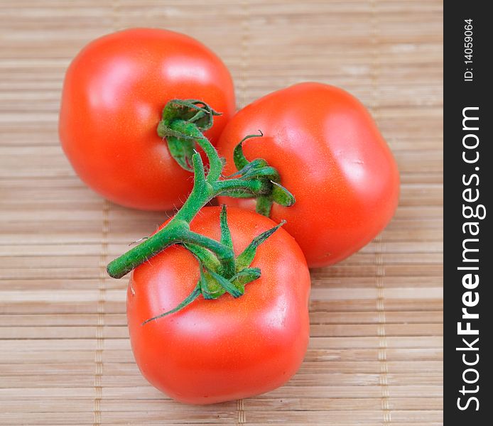 Red salad and tomato on brown bamboo napkin. Red salad and tomato on brown bamboo napkin