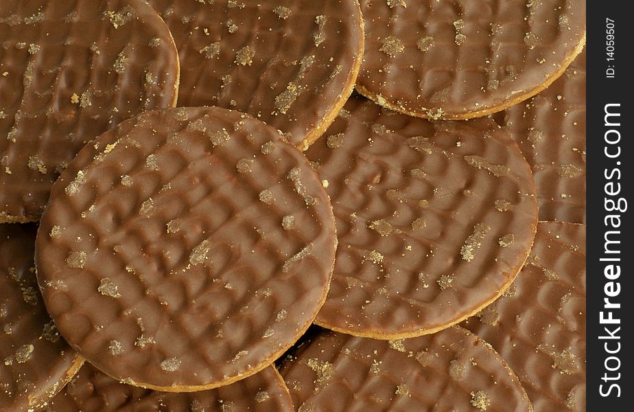 A close up of a pile of chocolate biscuits. A close up of a pile of chocolate biscuits