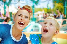 Mother And Child Travellers In Amusement Park Enjoying Ride Stock Images