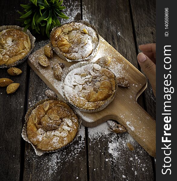 Loaf of Homemade Bread Lounge Almond Danish Pastry on wooden background with blank space