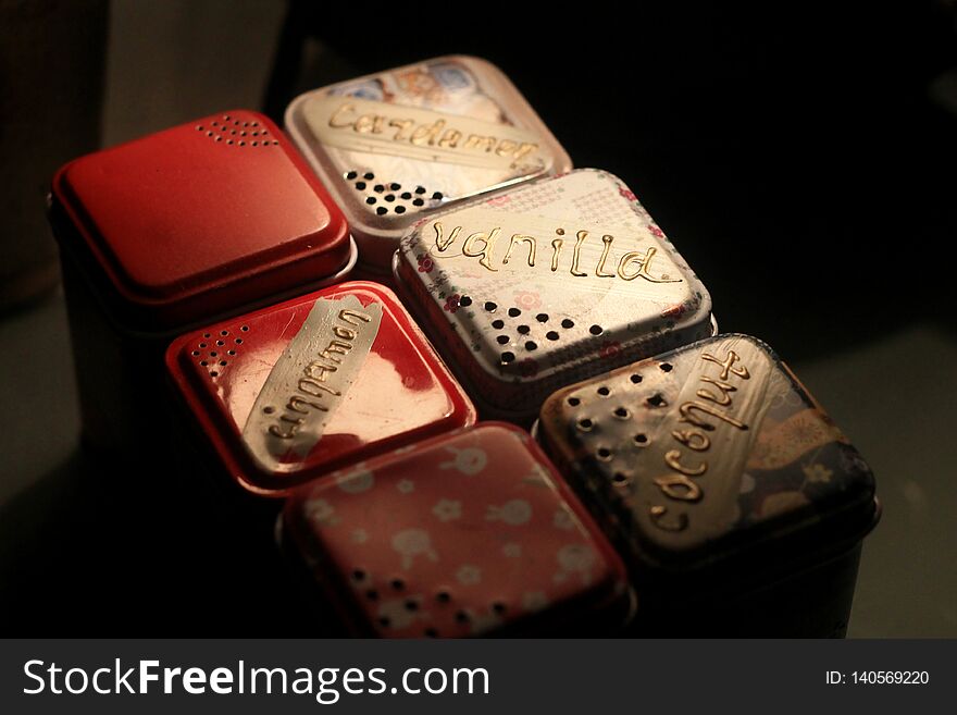 Multi-colored set of metal boxes with spices for home or cafe