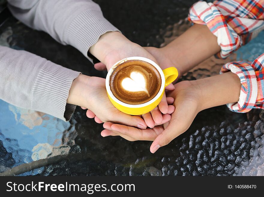 Romantic Couple In Love Hand Holding Two Cups Of Latte Art With Pattern The Heart On Table In Coffee Shop