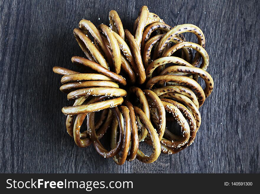 Bunch of bagels with sesame on wooden table