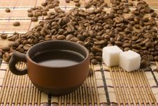 A Cup Of Coffee And Sugar Cubes Among Coffee Beans Royalty Free Stock Photography