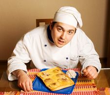 Handsome Young Chef In The Living Room With Cake O Stock Image Handsome Young Chef In The Living Room With Cake O Stock Image