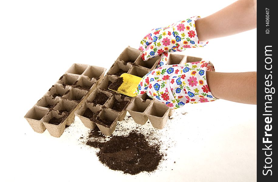 Gloves with Shovel Placing Soil into Compost Pots