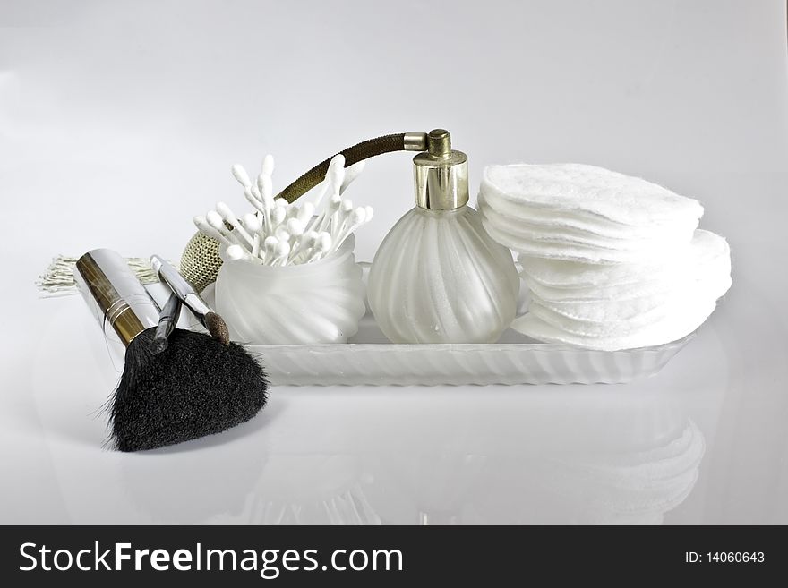 Make up and toiletry accessories on white background. Little reflection  of the objects on the background