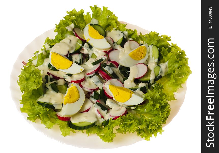 Salad with slice of egg on green lettuce. Plate isolated on white. Salad with slice of egg on green lettuce. Plate isolated on white