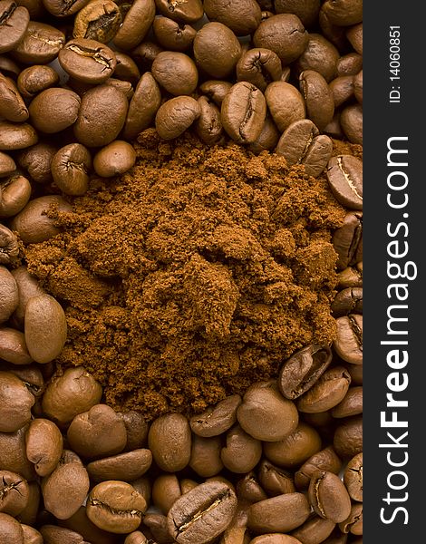 Coffee beans and ground coffee, mixed together and being shoot from above. Coffee beans and ground coffee, mixed together and being shoot from above