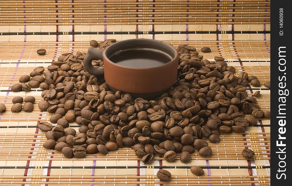 A Cup Of Coffee Among Coffee Beans
