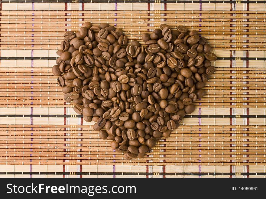 Coffee beans in a shape of heart being shoot from above. Coffee beans in a shape of heart being shoot from above.