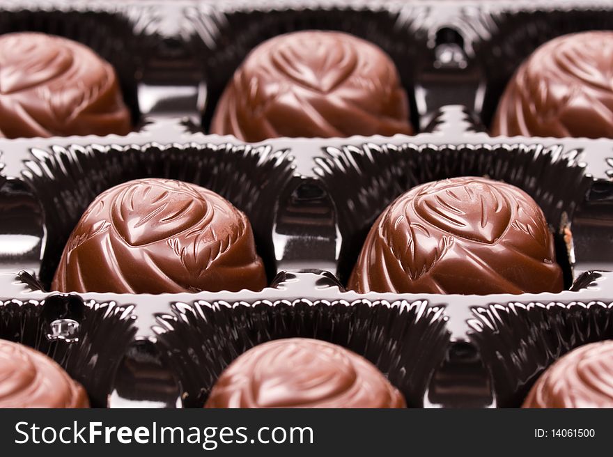 Chocolate candies in dark box � close up