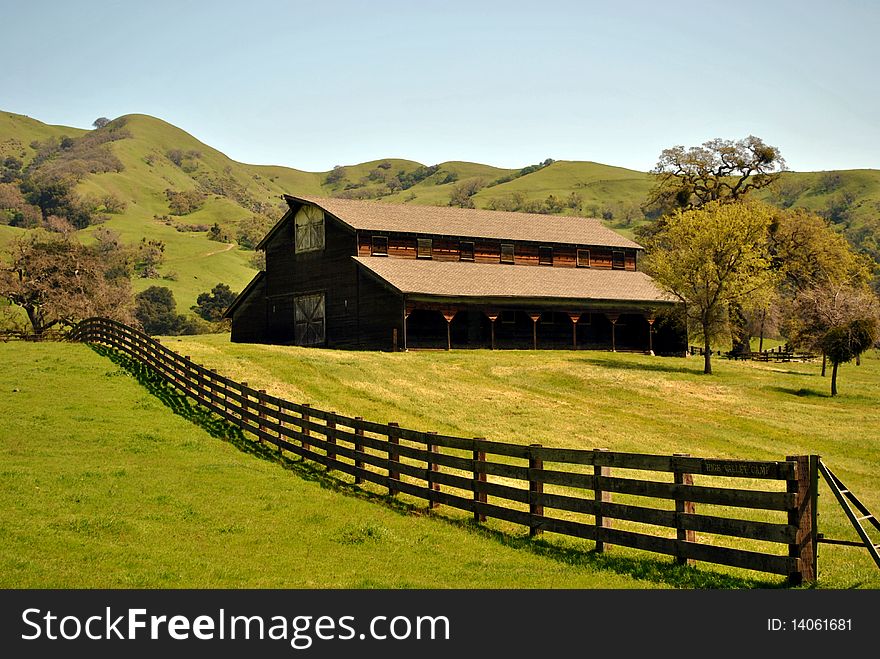 Old ranch barn in the green meadow hills. Old ranch barn in the green meadow hills.