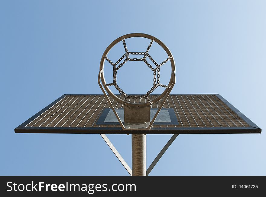 Metal basketball hoop outside with blue sky