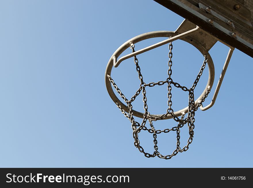 Outdoor basketball hoop with blue sky