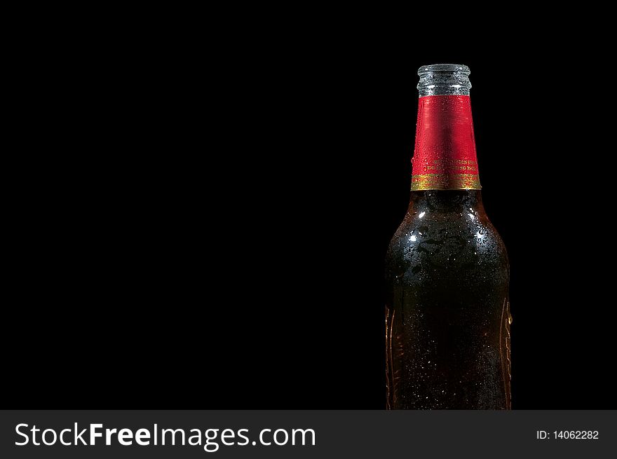Wet beer on a black background with lots of empty space. Wet beer on a black background with lots of empty space.