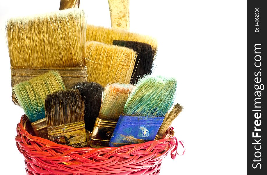 Various used Paintbrushes in a wicker basket