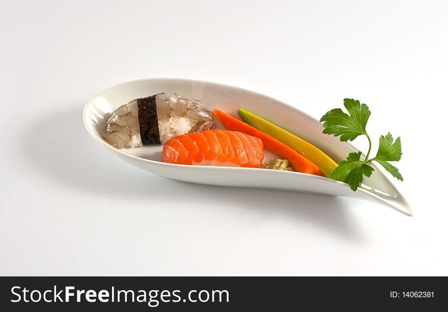 Sushi, shirmp and salmon nighiri on a saucer isolated on a white background. Sushi, shirmp and salmon nighiri on a saucer isolated on a white background