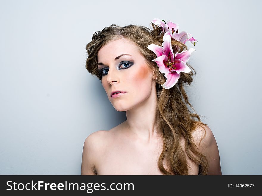 Close-up of beautiful girl with flowers On white background