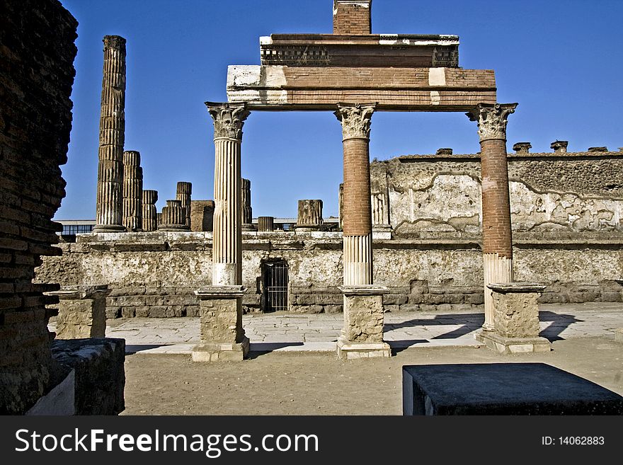 Ancient ruins of a public square in Pompeii with Corinthian columns holding whats left of a roofline. Ancient ruins of a public square in Pompeii with Corinthian columns holding whats left of a roofline