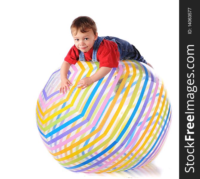 A two-year-old balanced over the top of a giant beach ball.  Isolated on white. A two-year-old balanced over the top of a giant beach ball.  Isolated on white.