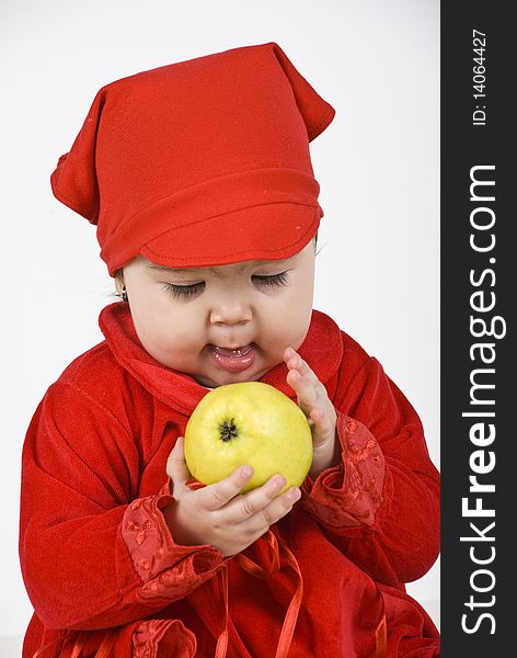 Baby girl holding and caress an apple