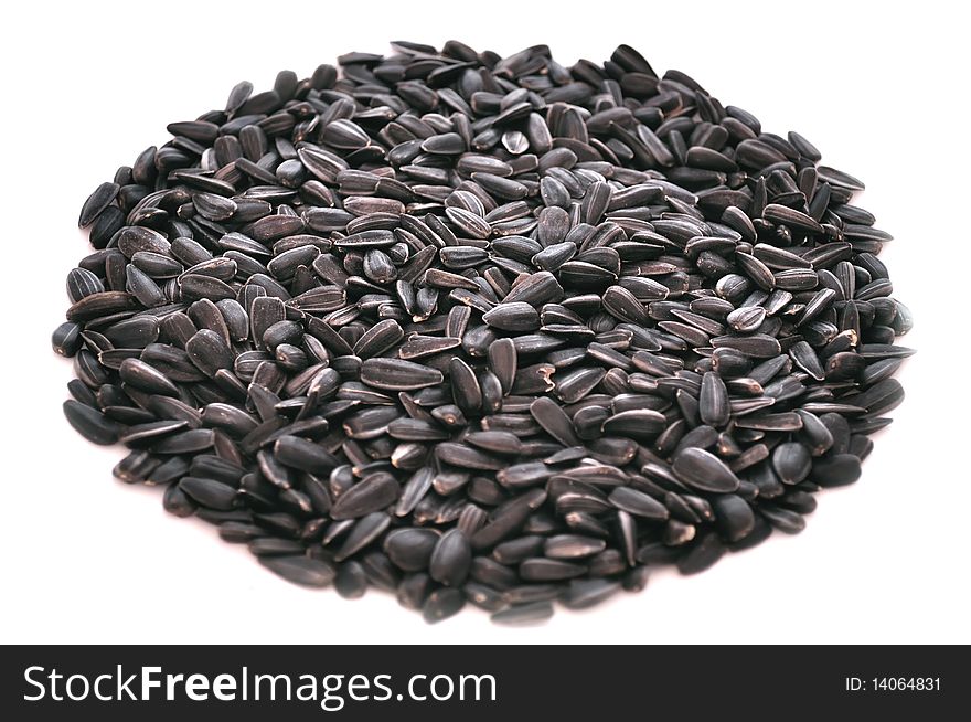 Unpeeled sunflower seeds isolated on a white background