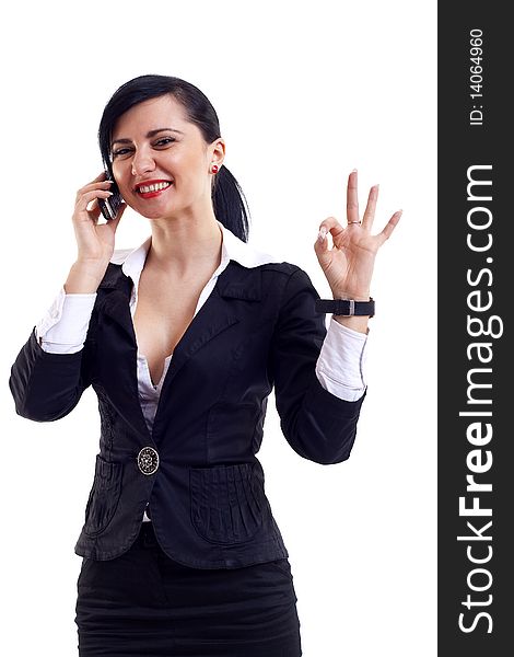 Picture of an attractive businesswoman on the phone winning and making her ok sign