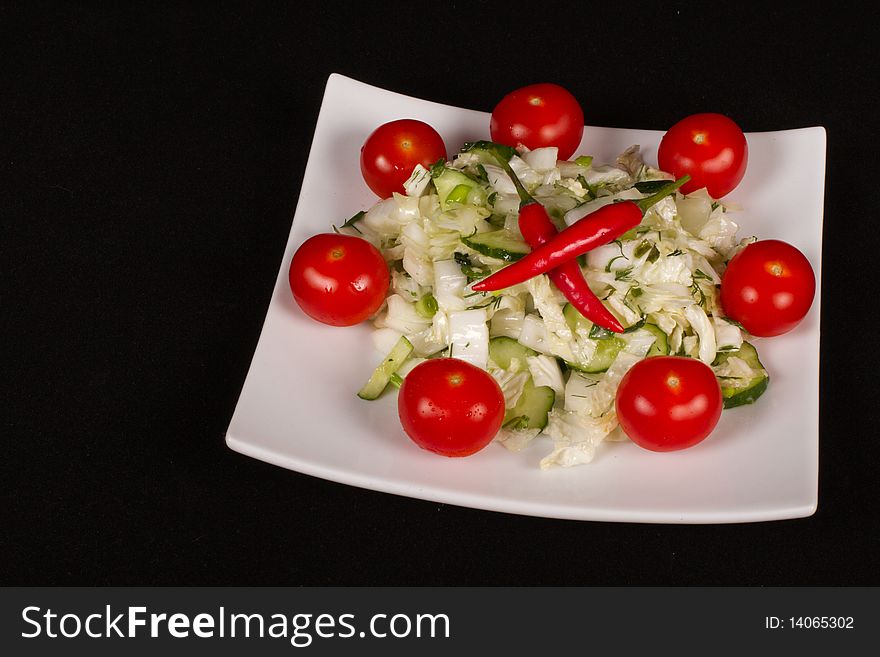 Salad with fresh cabbage, tomato, chilli, cucumber .