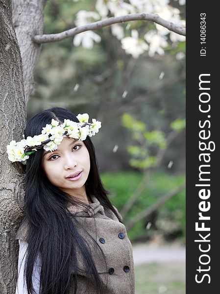 Beautiful Chinese girl holding garlands under cherry tree. Beautiful Chinese girl holding garlands under cherry tree.