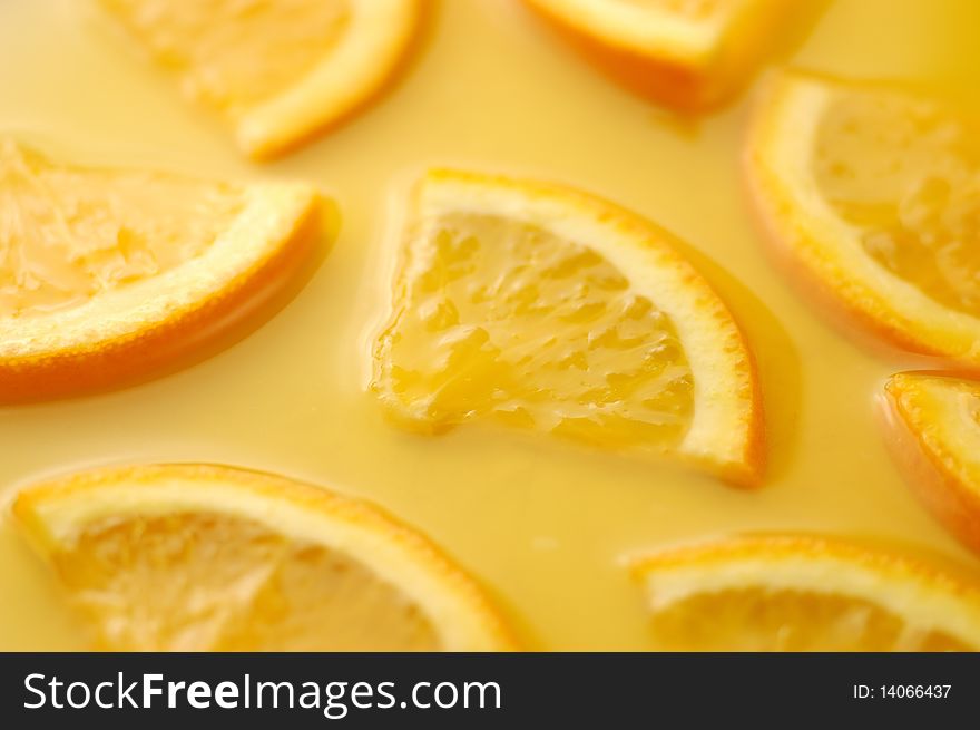 Orange slices in juice background