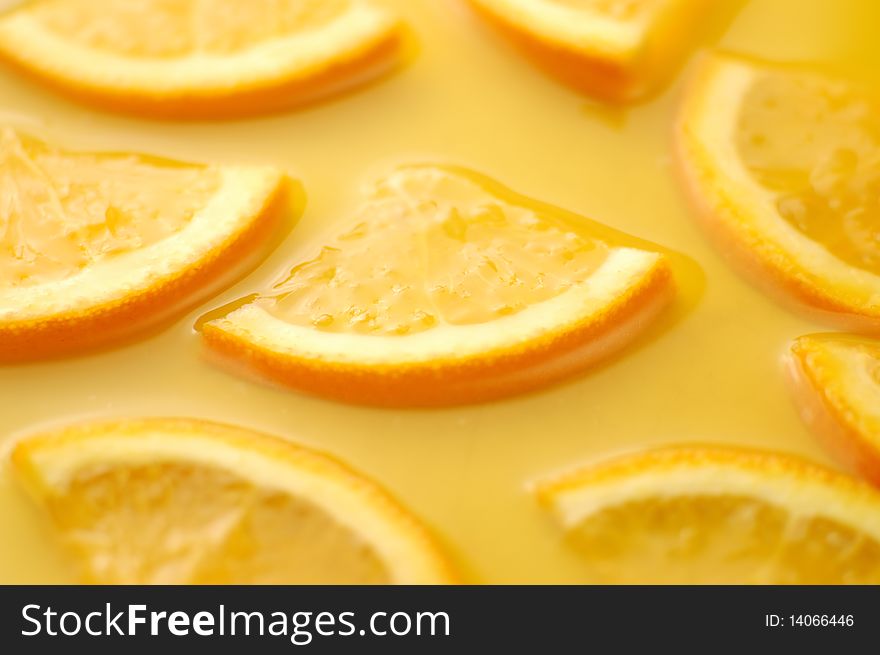 Orange slices in juice background