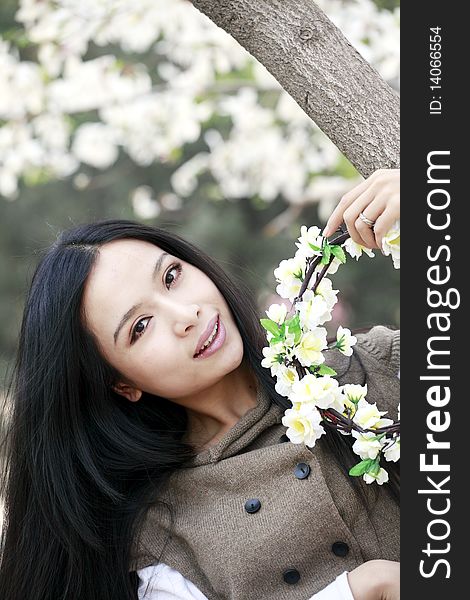 Beautiful Chinese girl holding garlands under cherry blossom tree. Beautiful Chinese girl holding garlands under cherry blossom tree.