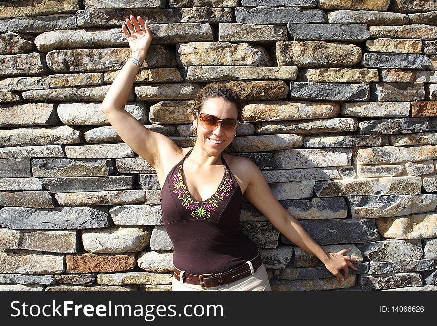 Beautiful Colombian woman with a brick wall background