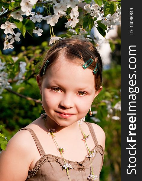 Portrait of the beautiful little girl in spring garden. Portrait of the beautiful little girl in spring garden