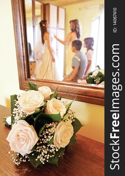 Details of bride bouquet and bride preparation in mirror reflection.