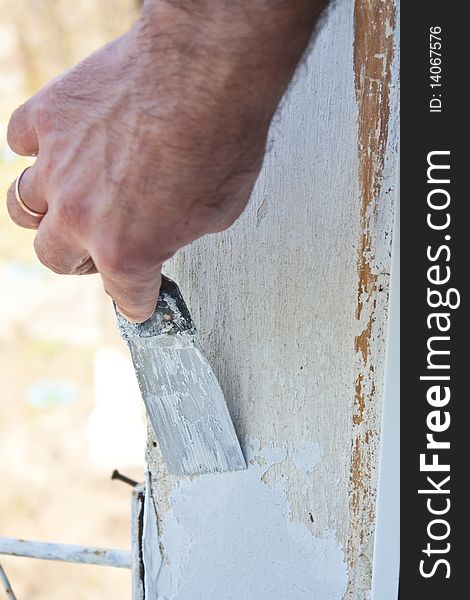 Puttying of a wall by a hand with spatula, repair work